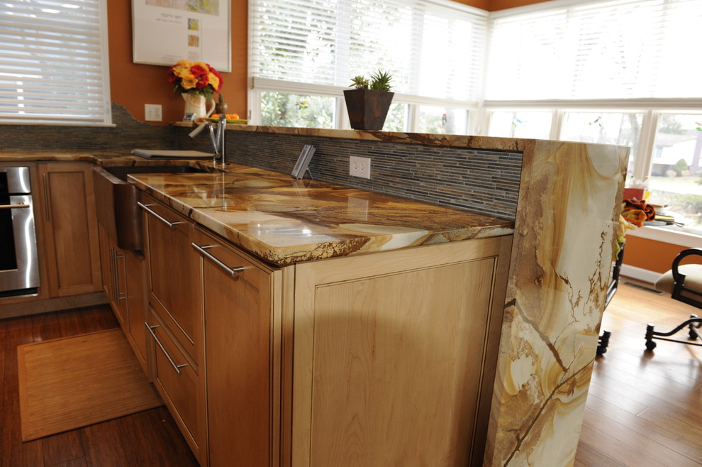Mid-sized transitional u-shaped light wood floor eat-in kitchen photo in Baltimore with a farmhouse sink, light wood cabinets, onyx countertops, stainless steel appliances, an island and beaded inset cabinets