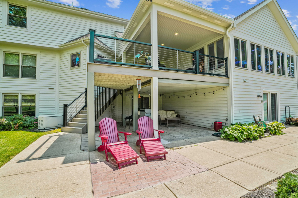 Deck - mid-sized transitional backyard second story cable railing deck idea in Columbus with a roof extension