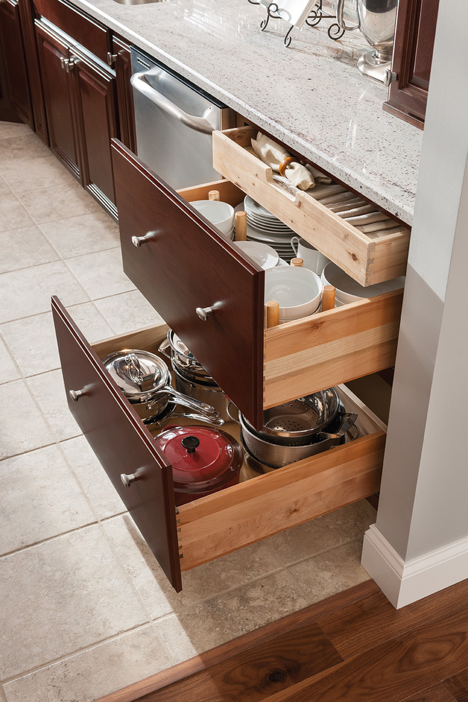 Kitchen - limestone floor kitchen idea in DC Metro with raised-panel cabinets, dark wood cabinets, quartz countertops and stainless steel appliances