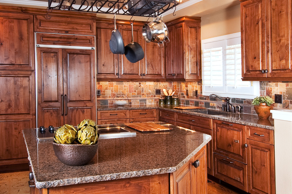Example of a large transitional u-shaped medium tone wood floor eat-in kitchen design in Denver with an undermount sink, dark wood cabinets, granite countertops, brown backsplash, ceramic backsplash, paneled appliances and an island