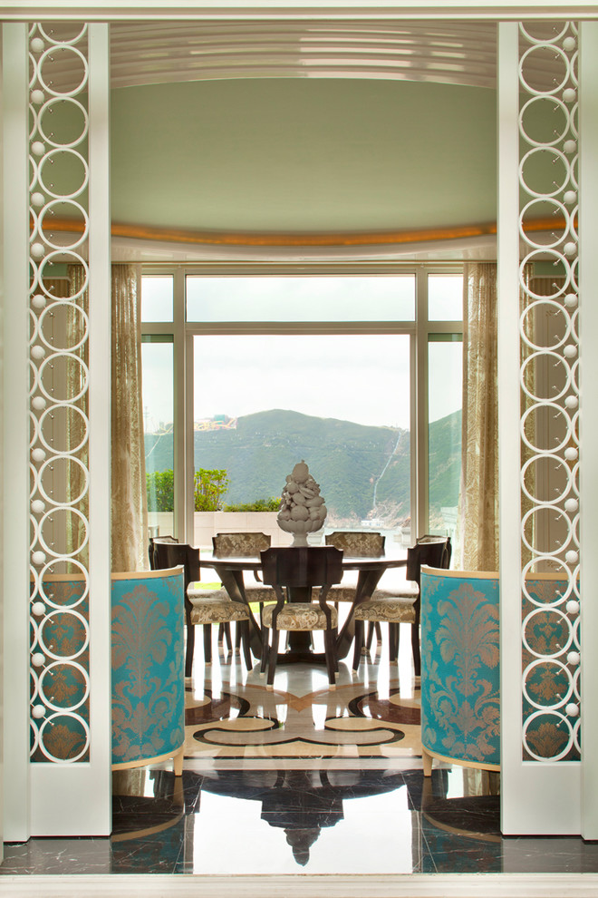 This is an example of an expansive eclectic separate dining room in Hong Kong with green walls and marble floors.