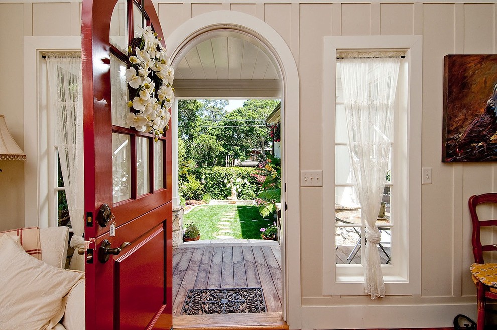Mid-sized traditional foyer in Seattle with a dutch front door, beige walls, light hardwood floors and a red front door.
