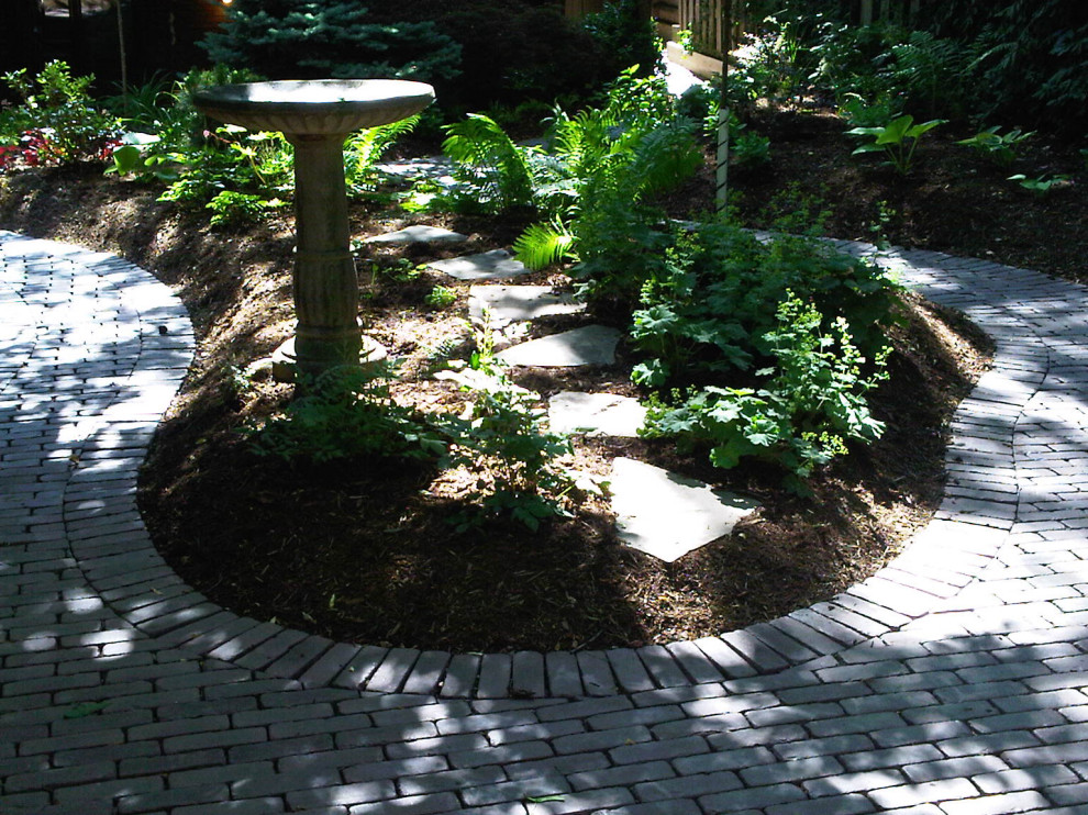 Inspiration for a mid-sized backyard shaded garden for summer in Toronto with with flowerbed and brick pavers.