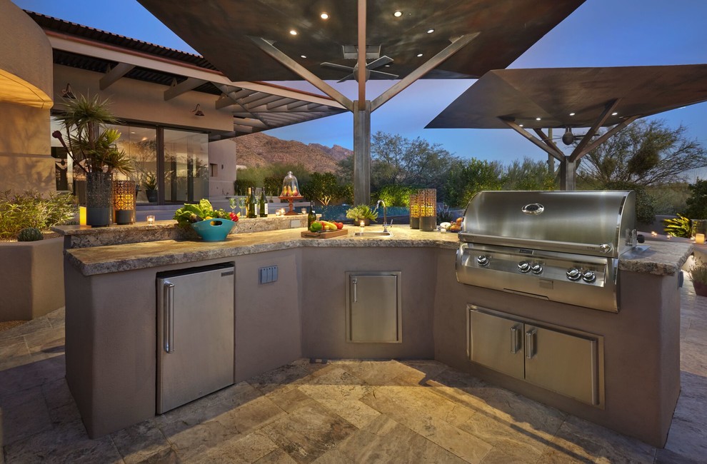 This is an example of a large contemporary backyard patio in Phoenix with an outdoor kitchen, tile and a gazebo/cabana.