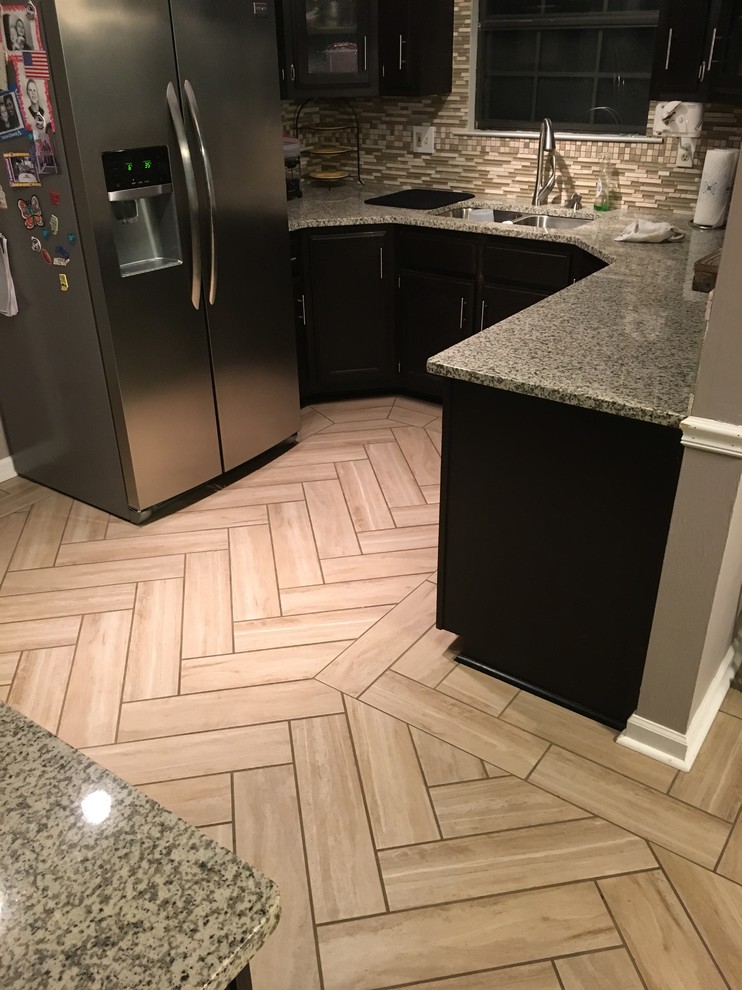 Enclosed kitchen - mid-sized transitional u-shaped porcelain tile and beige floor enclosed kitchen idea with a double-bowl sink, dark wood cabinets, quartz countertops, multicolored backsplash, matchstick tile backsplash, stainless steel appliances and no island