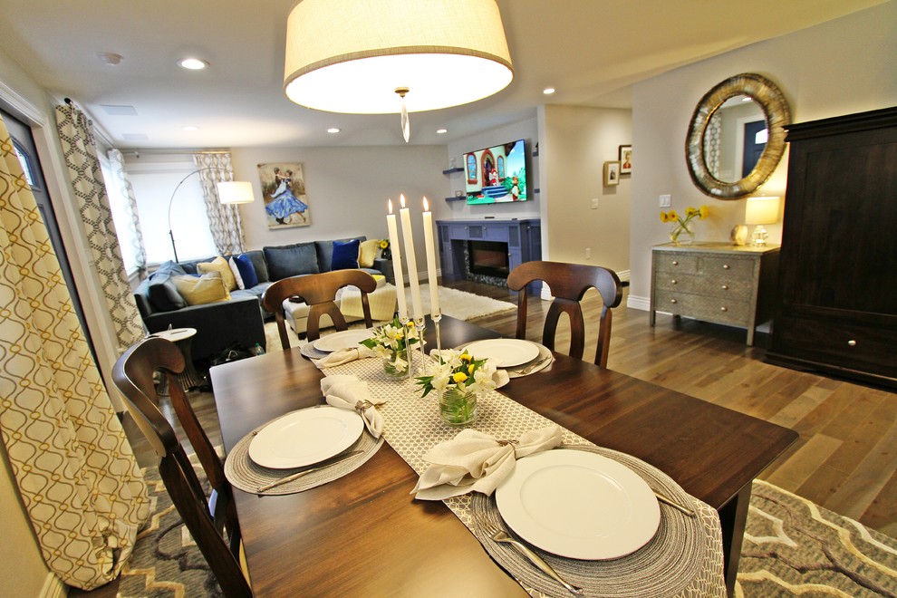 Example of a mid-sized transitional light wood floor great room design in Seattle with beige walls and a standard fireplace