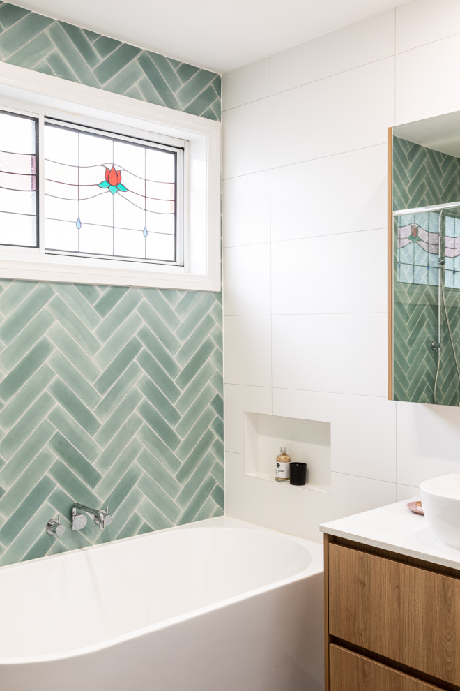 Small modern kids bathroom in Melbourne with flat-panel cabinets, medium wood cabinets, a corner tub, a corner shower, green tile, a vessel sink, engineered quartz benchtops, grey floor, a hinged shower door, yellow benchtops, a single vanity and a floating vanity.