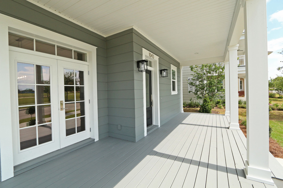 Inspiration for a mid-sized traditional front yard verandah in Orlando with decking and a roof extension.