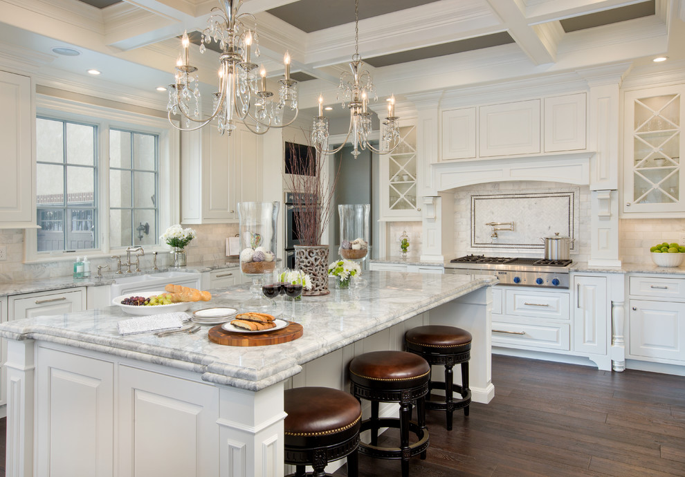 Design ideas for a large traditional l-shaped kitchen in Columbus with a farmhouse sink, white cabinets, granite benchtops, with island, raised-panel cabinets, white splashback, stainless steel appliances and dark hardwood floors.