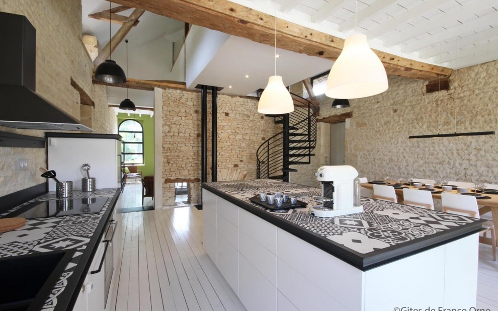 Inspiration for a large galley eat-in kitchen in Paris with an undermount sink, beaded inset cabinets, white cabinets, tile benchtops, black splashback, cement tile splashback, painted wood floors, with island, white floor, black benchtop and black appliances.