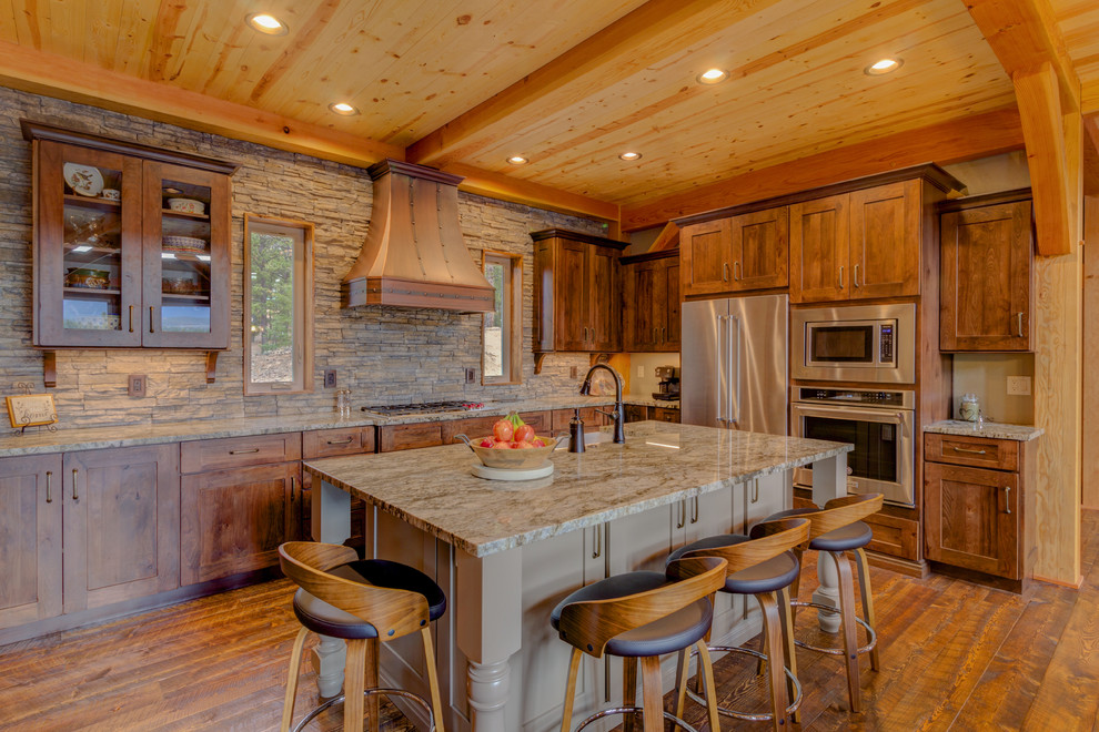 Kitchen - rustic l-shaped dark wood floor and brown floor kitchen idea in Denver with a farmhouse sink, shaker cabinets, dark wood cabinets, stainless steel appliances, an island and gray countertops