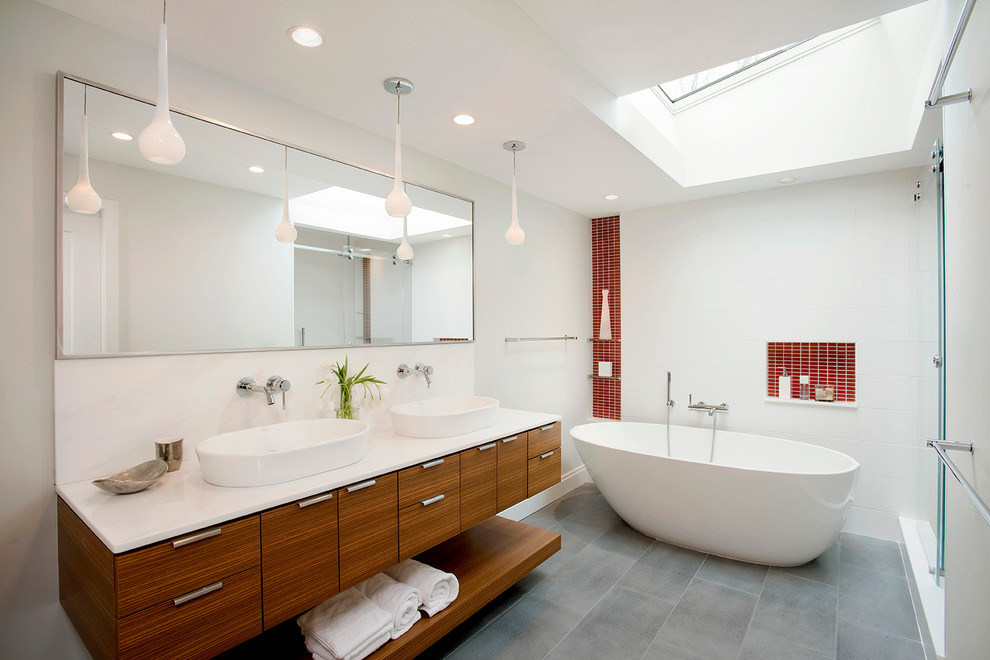This is an example of a contemporary master bathroom in Boston with flat-panel cabinets, medium wood cabinets, a freestanding tub, red tile, white walls, a vessel sink and a sliding shower screen.