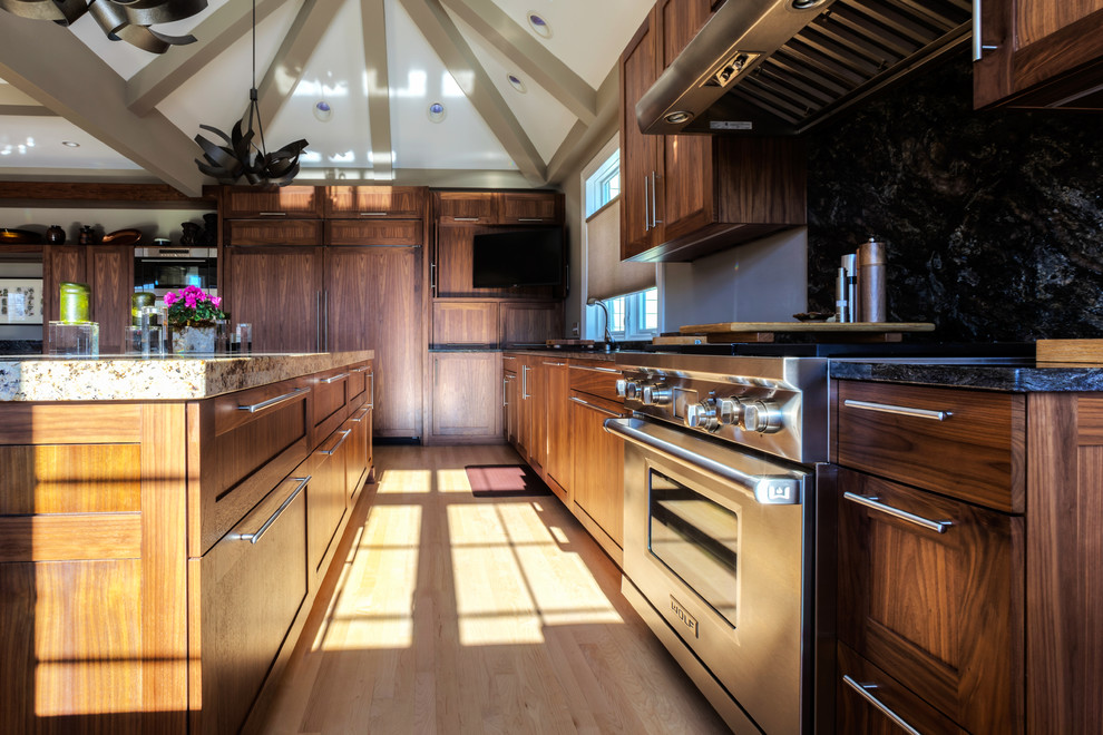 Huge transitional u-shaped light wood floor eat-in kitchen photo in Chicago with recessed-panel cabinets, medium tone wood cabinets, granite countertops, stainless steel appliances, an island, an undermount sink, green backsplash and stone slab backsplash