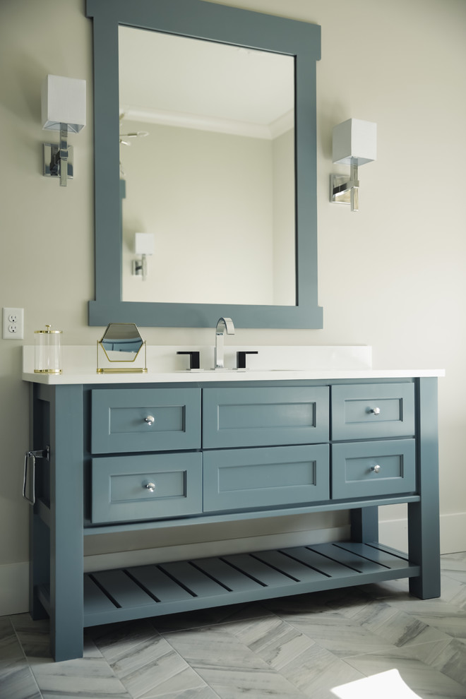 Example of a large transitional master porcelain tile and gray floor bathroom design in Charleston with furniture-like cabinets, blue cabinets, gray walls, an undermount sink, quartz countertops and white countertops