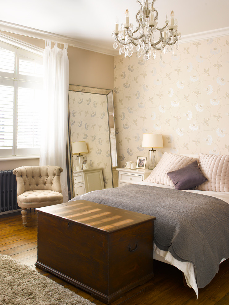 Photo of a large traditional bedroom in London with beige walls and dark hardwood floors.