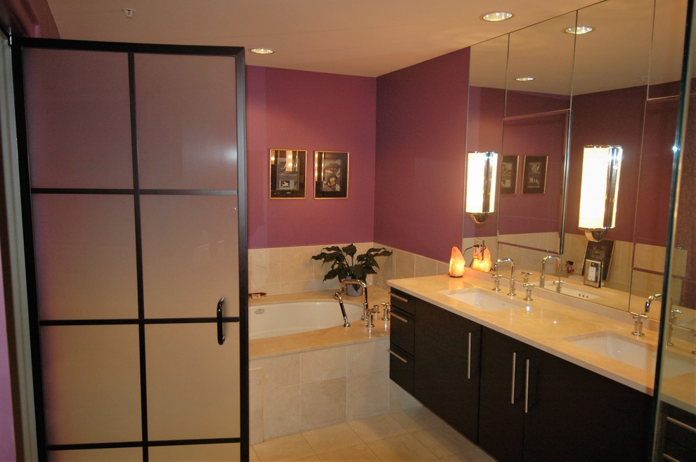 This is an example of a modern master bathroom in Baltimore with flat-panel cabinets, brown cabinets, an undermount tub, a corner shower, a one-piece toilet, multi-coloured tile, multi-coloured walls, marble floors, an undermount sink, marble benchtops, orange floor, a hinged shower door and beige benchtops.