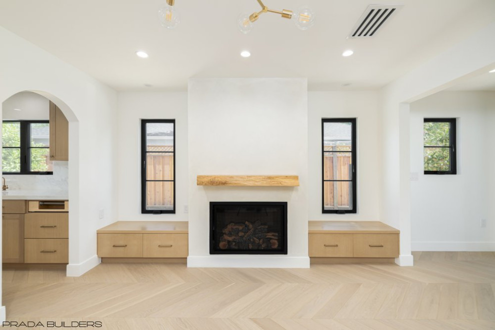 Design ideas for a large contemporary formal open concept living room in Other with white walls, light hardwood floors, a standard fireplace, a plaster fireplace surround, no tv and beige floor.
