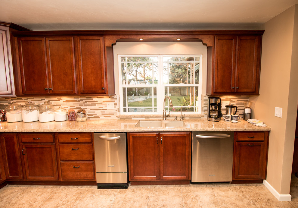 Large transitional u-shaped porcelain tile kitchen photo with an undermount sink, flat-panel cabinets, medium tone wood cabinets, quartz countertops, beige backsplash, mosaic tile backsplash, stainless steel appliances and an island