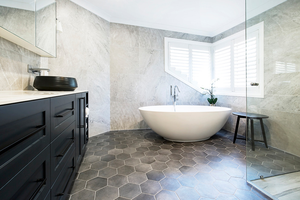 Photo of a large master bathroom in Sydney with shaker cabinets, black cabinets, a freestanding tub, a corner shower, black and white tile, ceramic tile, white walls, ceramic floors, a vessel sink, tile benchtops, brown floor, a hinged shower door and multi-coloured benchtops.