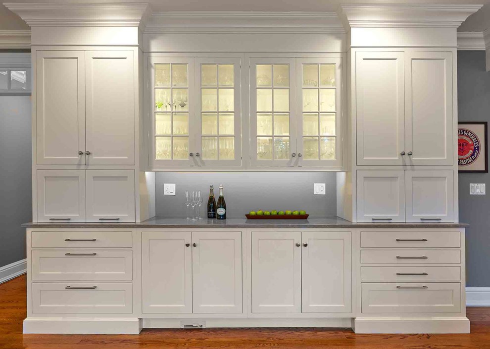 Large transitional l-shaped medium tone wood floor and brown floor eat-in kitchen photo in Bridgeport with a drop-in sink, beaded inset cabinets, white cabinets, limestone countertops, white backsplash, ceramic backsplash, stainless steel appliances, an island and gray countertops
