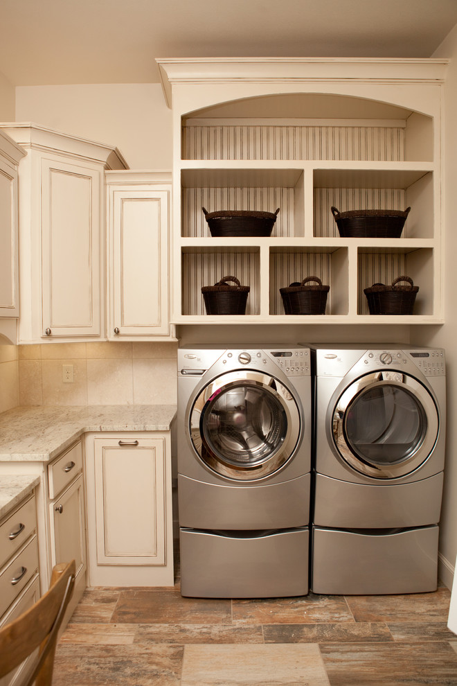 Inspiration for a large traditional u-shaped dedicated laundry room in Dallas with beaded inset cabinets, white cabinets, granite benchtops, white walls, vinyl floors, a side-by-side washer and dryer, multi-coloured floor and multi-coloured benchtop.