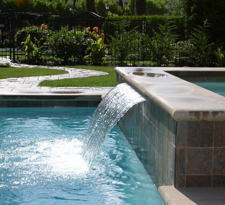 Photo of a large contemporary backyard rectangular pool in Seattle with stamped concrete.