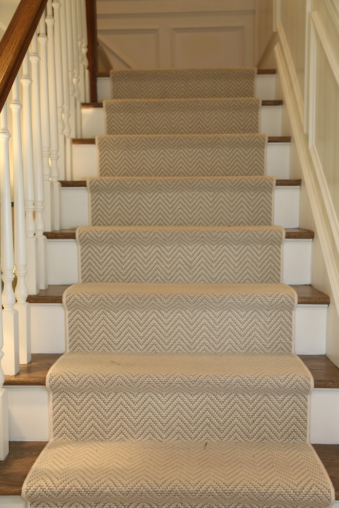 Design ideas for a mid-sized transitional carpeted l-shaped staircase in New York with carpet risers.