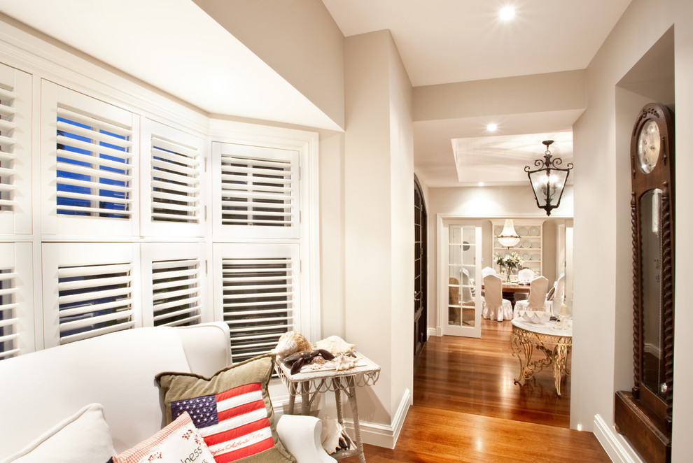 Photo of a beach style hallway in Gold Coast - Tweed with white walls and dark hardwood floors.