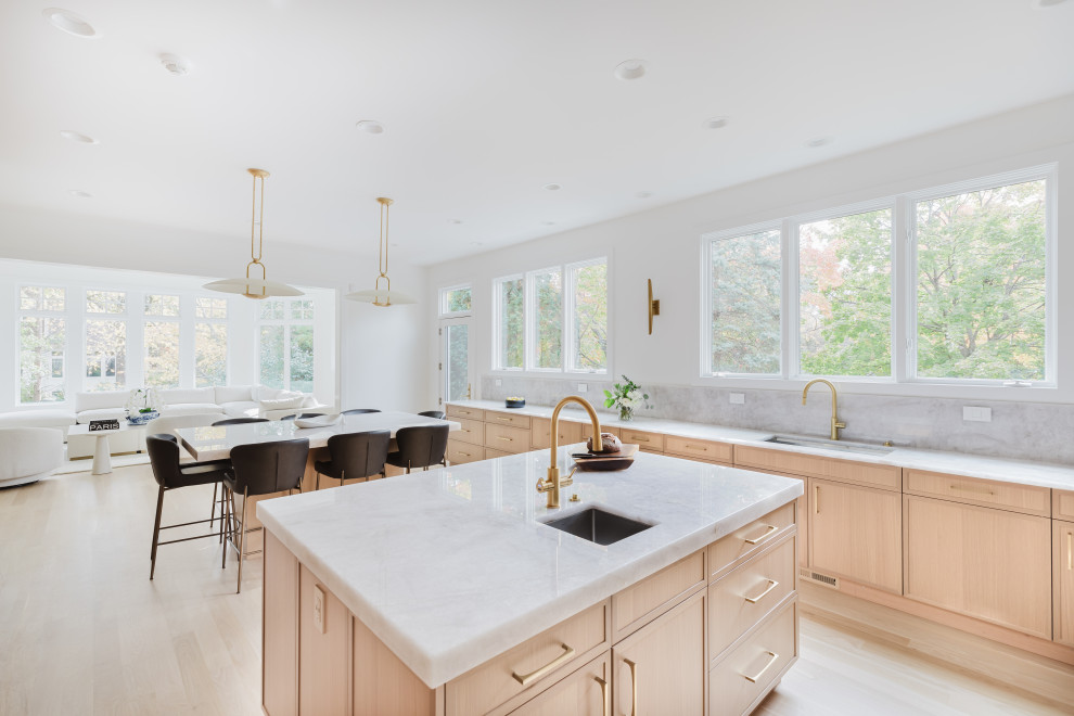 Modern Bright Kitchen With Marble Island and Large Windows Overlooking Greenery