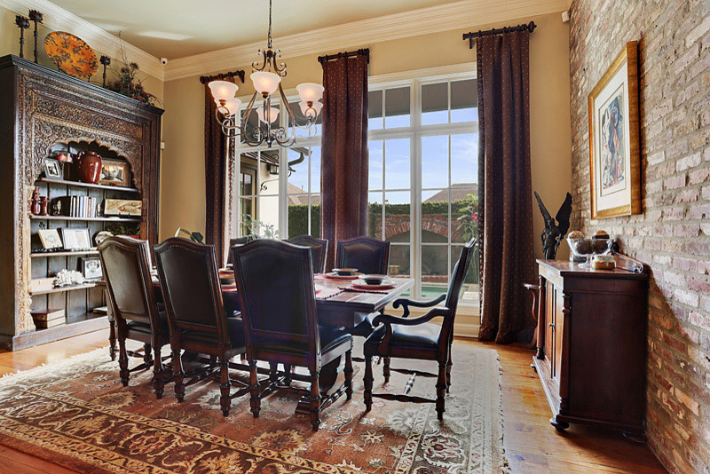 Photo of a mid-sized traditional dining room in New Orleans with beige walls and light hardwood floors.
