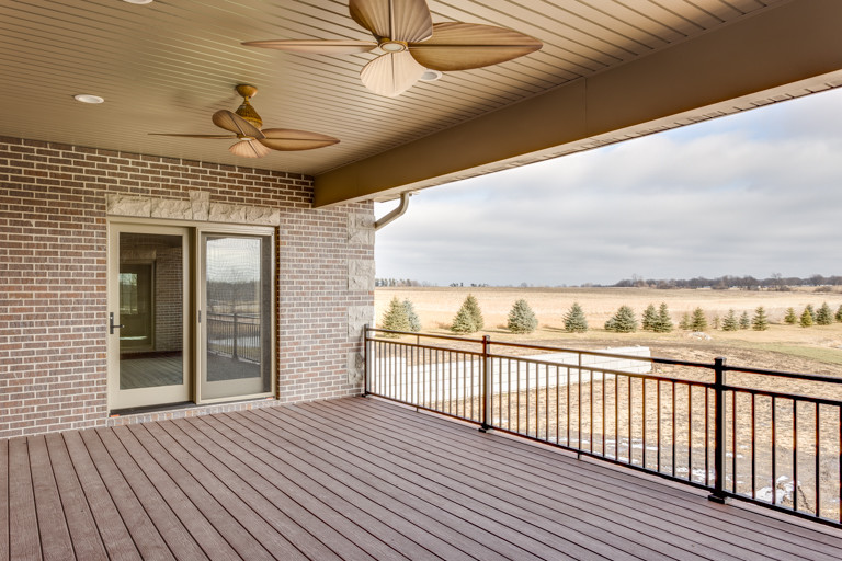 Mountain style deck photo with a roof extension