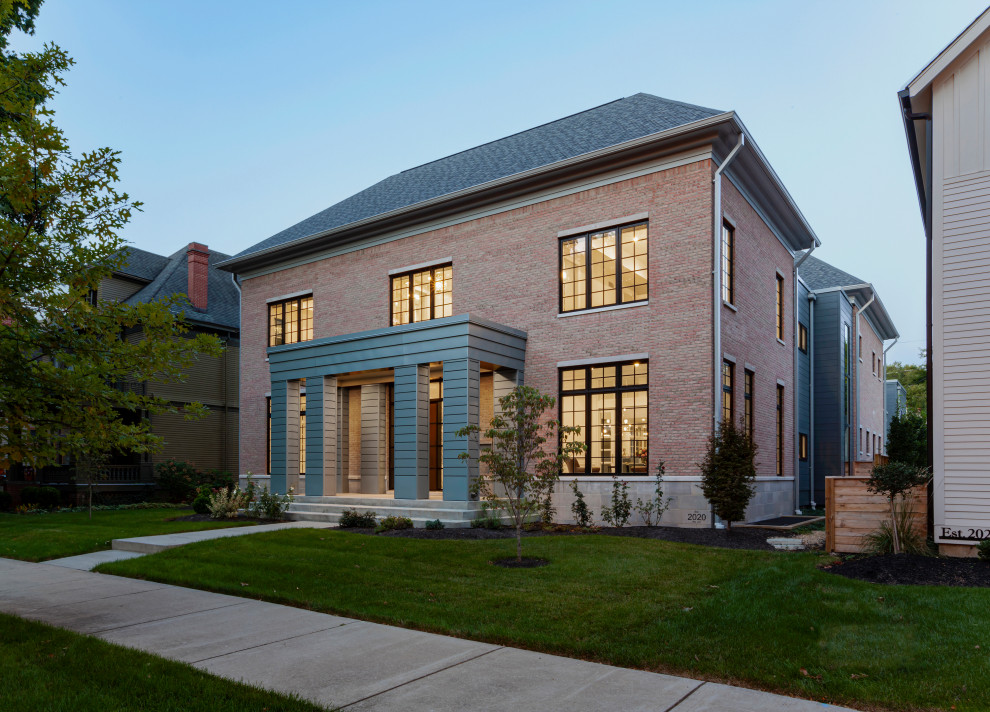 Mid-sized modern pink two-story brick house exterior idea in Indianapolis with a hip roof, a shingle roof and a gray roof