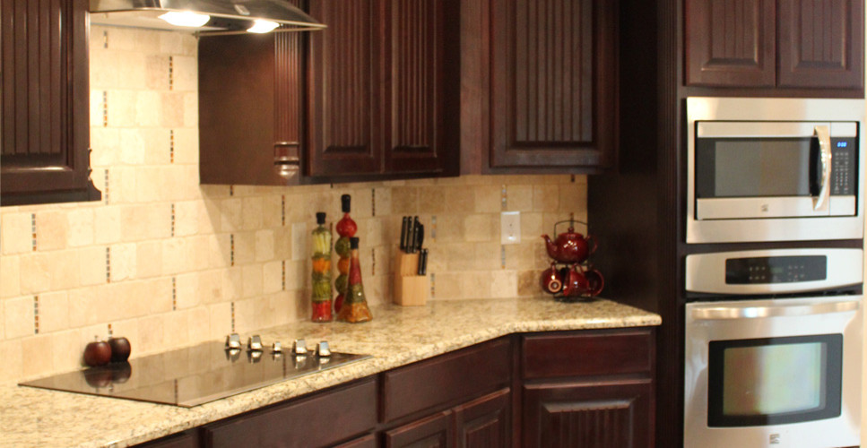 Inspiration for a large kitchen remodel in Austin with dark wood cabinets, beige backsplash, stone tile backsplash, stainless steel appliances and no island