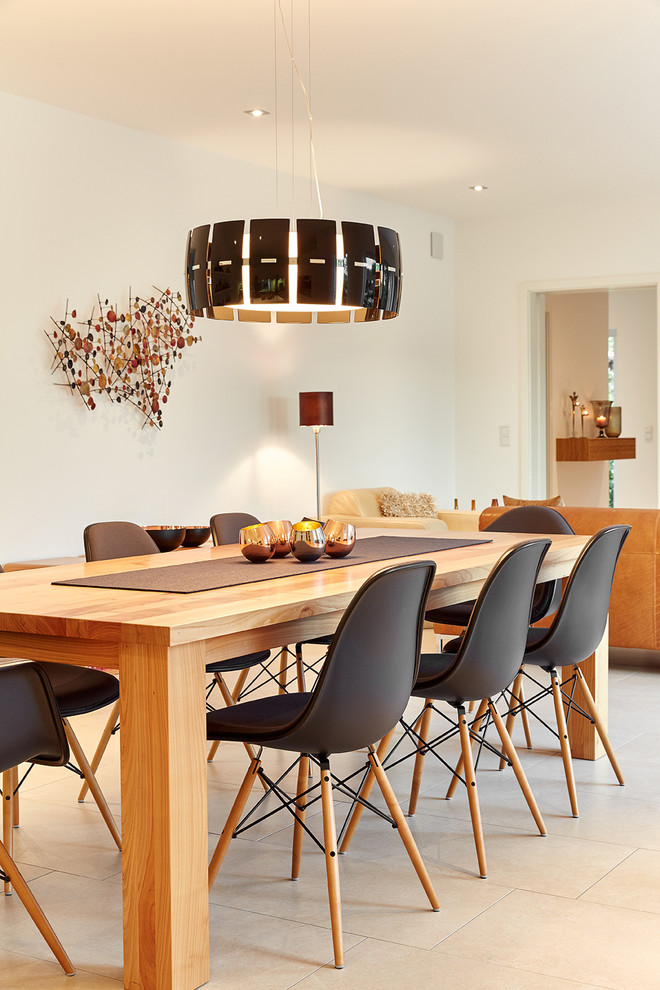 Photo of a mid-sized scandinavian open plan dining in Nuremberg with white walls, ceramic floors, no fireplace and beige floor.