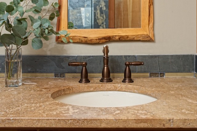 Design ideas for a mid-sized eclectic master bathroom in Seattle with an undermount sink, recessed-panel cabinets, medium wood cabinets, quartzite benchtops, an alcove shower, multi-coloured tile, stone tile, beige walls and slate floors.