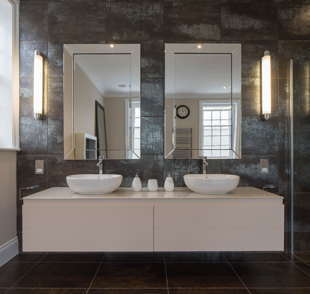This is an example of a contemporary bathroom in London with a vessel sink, flat-panel cabinets, white cabinets and brown walls.