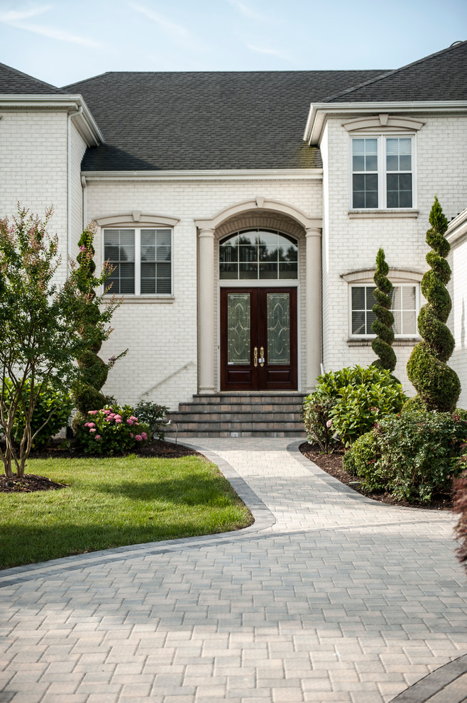 Inspiration for an expansive contemporary front yard driveway in Richmond with concrete pavers.