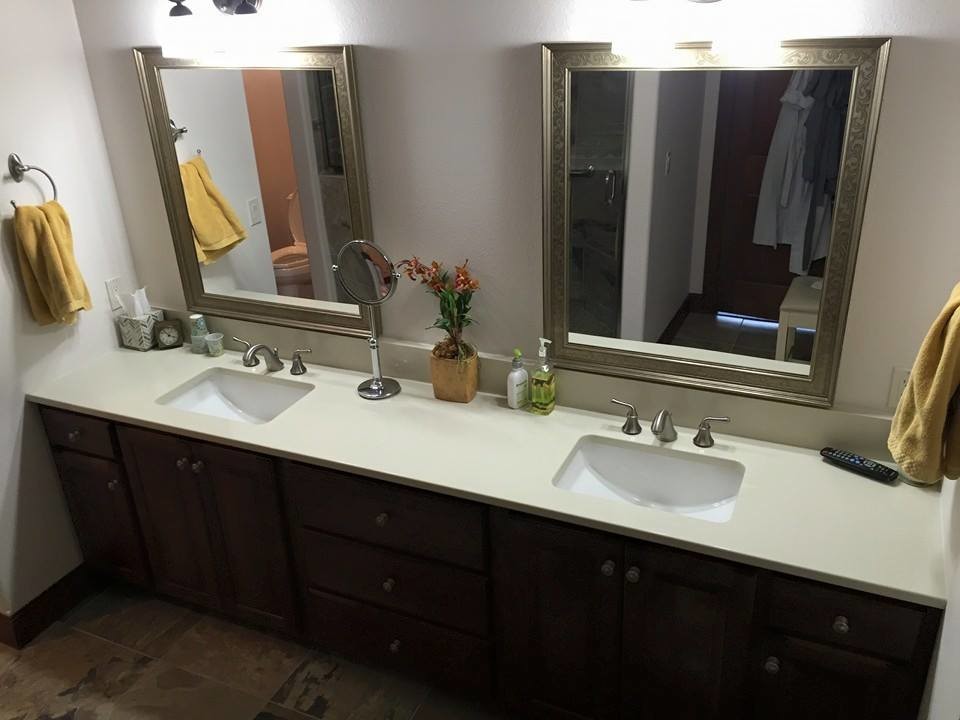 Large transitional master beige tile and stone tile slate floor bathroom photo with an undermount sink, dark wood cabinets, glass countertops and white walls