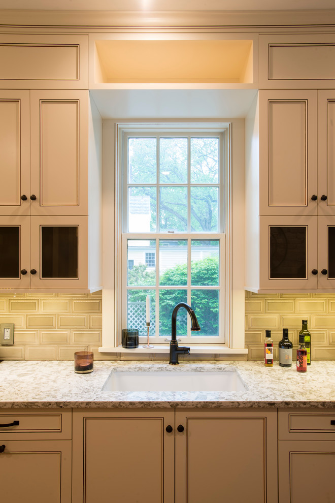 Inspiration for a mid-sized transitional u-shaped medium tone wood floor eat-in kitchen remodel in New York with an undermount sink, recessed-panel cabinets, white cabinets, subway tile backsplash, stainless steel appliances, a peninsula, granite countertops and beige backsplash