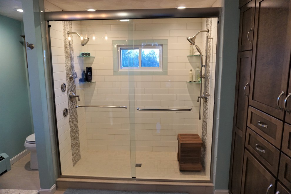 Example of a mid-sized transitional master white tile and subway tile porcelain tile and beige floor home design design in Providence with recessed-panel cabinets, brown cabinets, blue walls, an undermount sink, quartz countertops and multicolored countertops