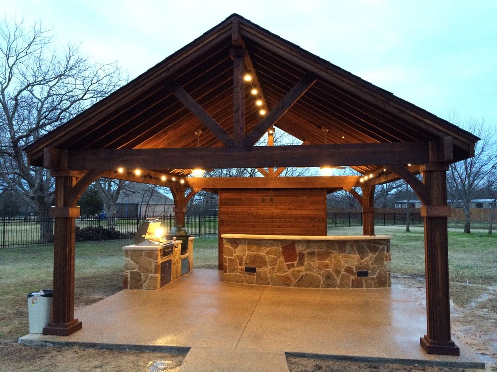 Inspiration for a mid-sized country backyard patio in Dallas with an outdoor kitchen, concrete slab and a gazebo/cabana.