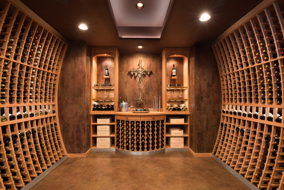Large transitional wine cellar in Minneapolis with concrete floors and storage racks.