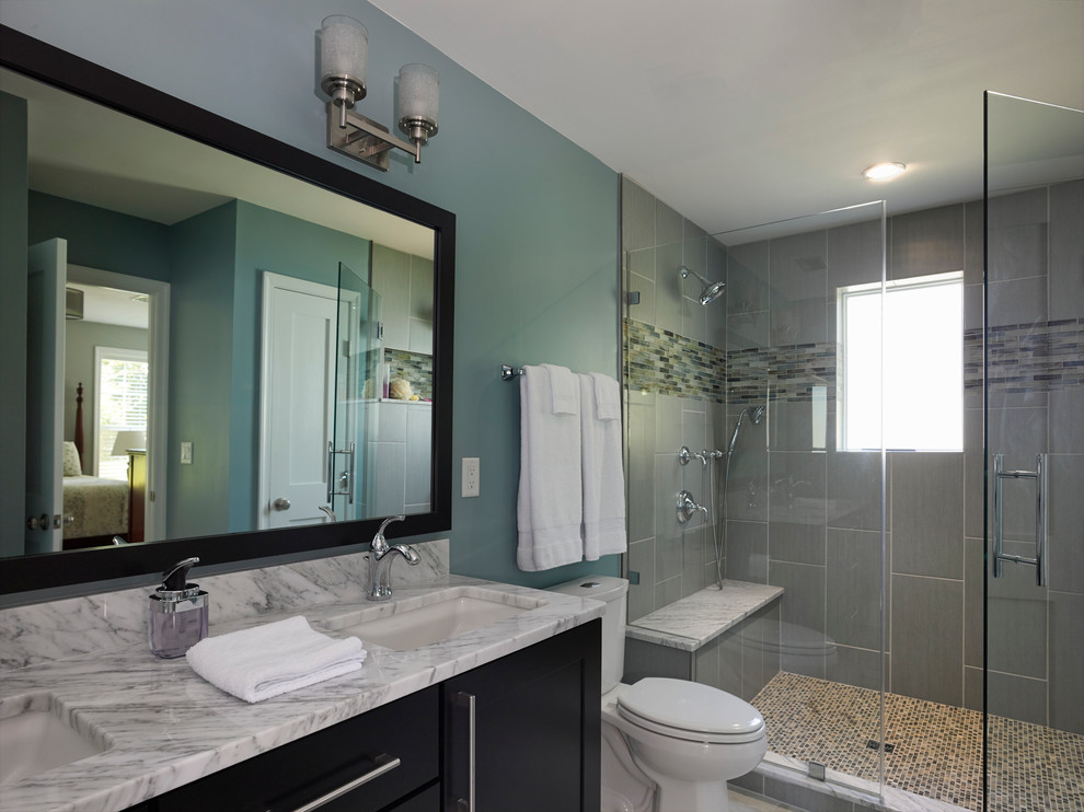 This is an example of a small midcentury 3/4 bathroom in Baltimore with an undermount sink, marble benchtops, gray tile, beige tile, blue walls, an alcove shower, shaker cabinets, black cabinets, a one-piece toilet, matchstick tile and porcelain floors.