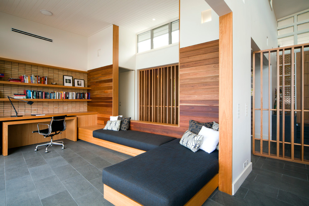 Contemporary home office in Sydney with white walls and grey floor.