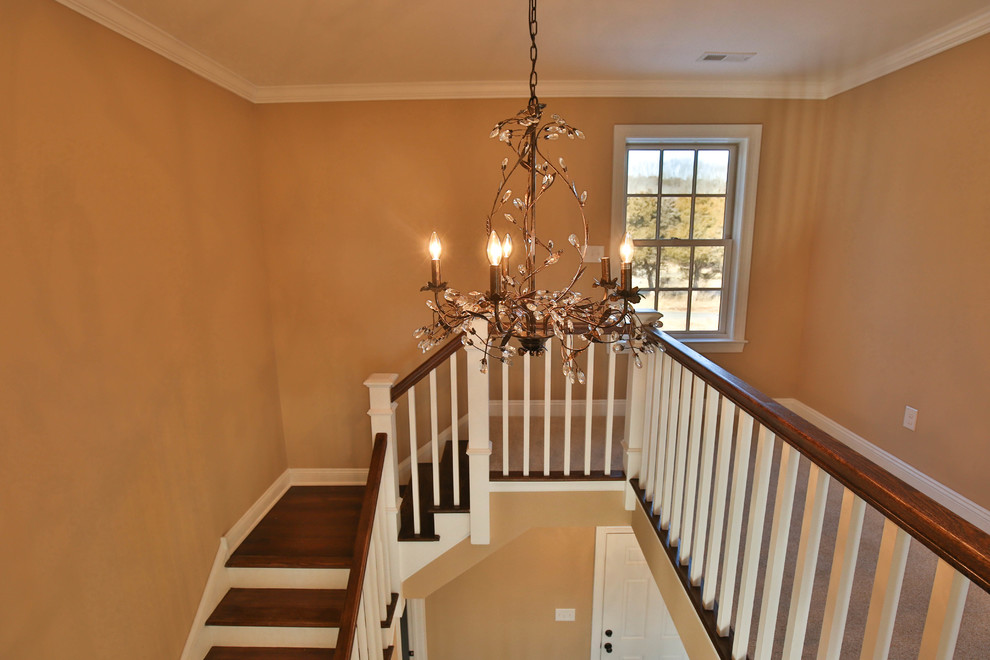 Mid-sized country wood l-shaped staircase in Philadelphia with painted wood risers.