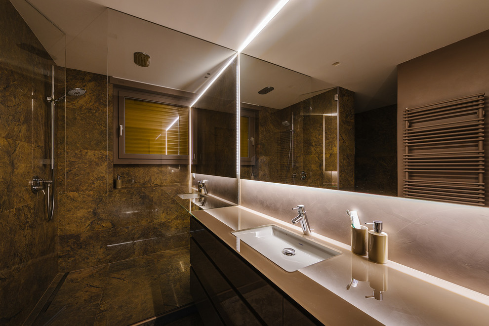 This is an example of a large contemporary 3/4 bathroom in Milan with a corner shower, stone slab, white walls, an integrated sink and a hinged shower door.