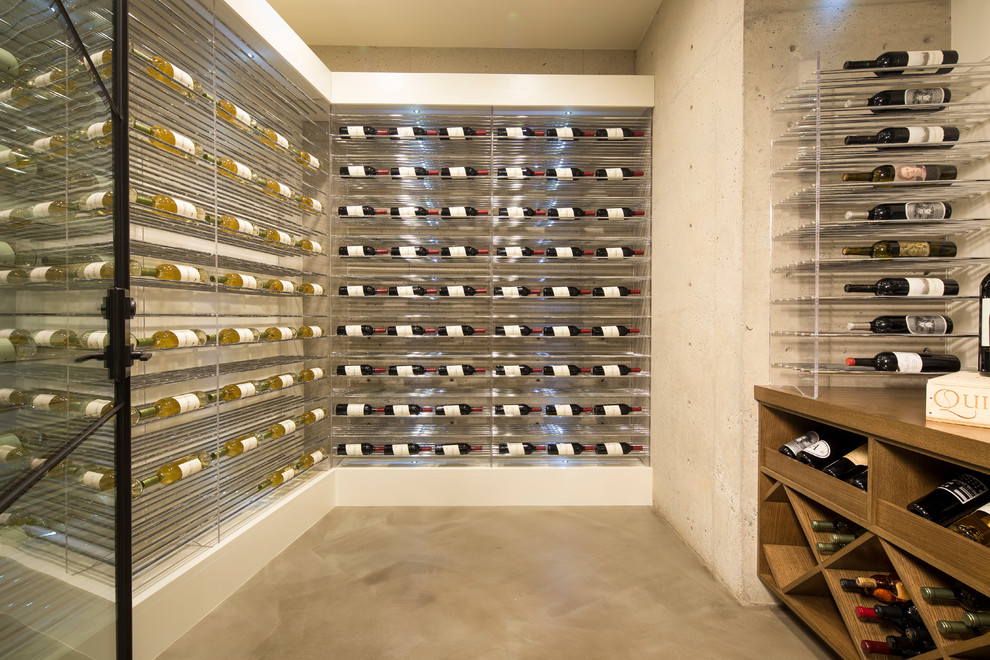 Inspiration for a contemporary wine cellar in Orange County with concrete floors and storage racks.