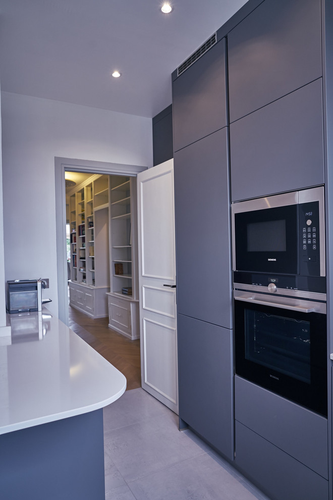 Contemporary u-shaped separate kitchen in Paris with beaded inset cabinets, grey cabinets, quartzite benchtops, white splashback, stainless steel appliances, ceramic floors and no island.