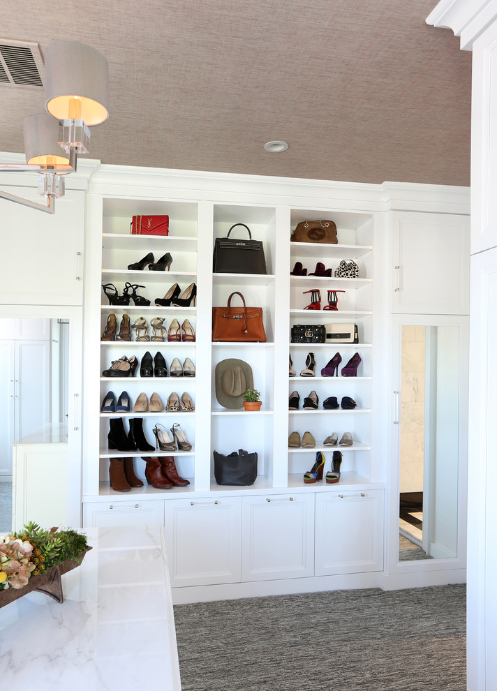 Example of a large classic gender-neutral carpeted and gray floor dressing room design with white cabinets