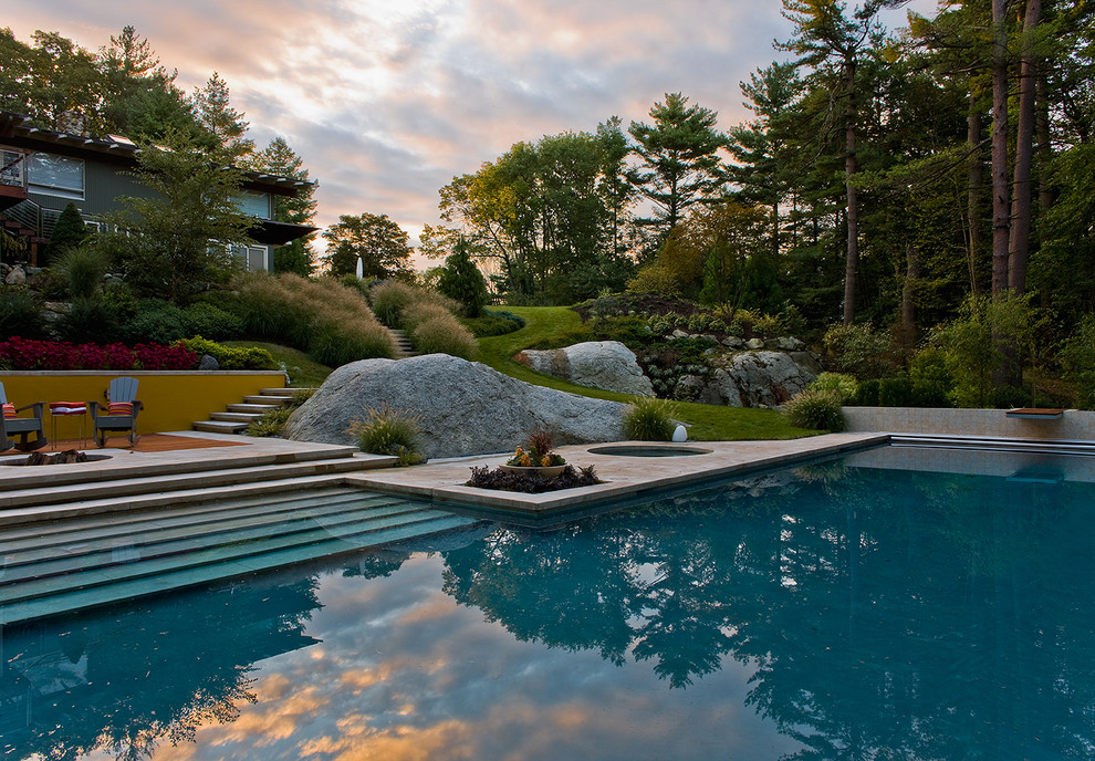 Photo of a large contemporary backyard rectangular lap pool in Boston with a hot tub and concrete slab.